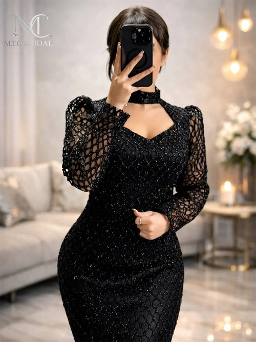 Black mermaid long sleeves evening dress by JN Fashion Fusion featuring glitter mesh fabric and a floor-length bodycon fit for special occasions.