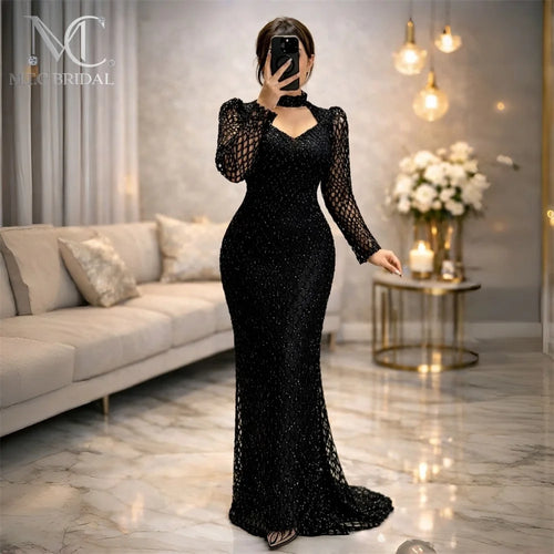 Black mermaid long sleeve evening dress by JN Fashion Fusion featuring glitter mesh, bodycon fit, floor-length for special occasions.