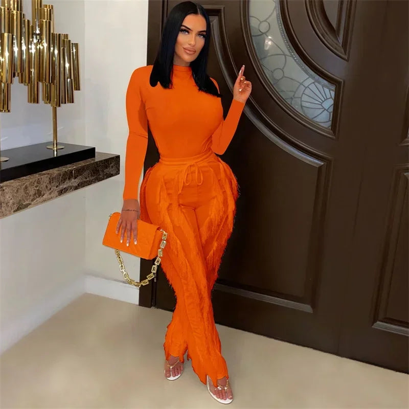 Elegant women's 2-piece fall winter outfit with long sleeve bodysuit and tassel pants by JN Fashion Fusion, shown in natural setting.