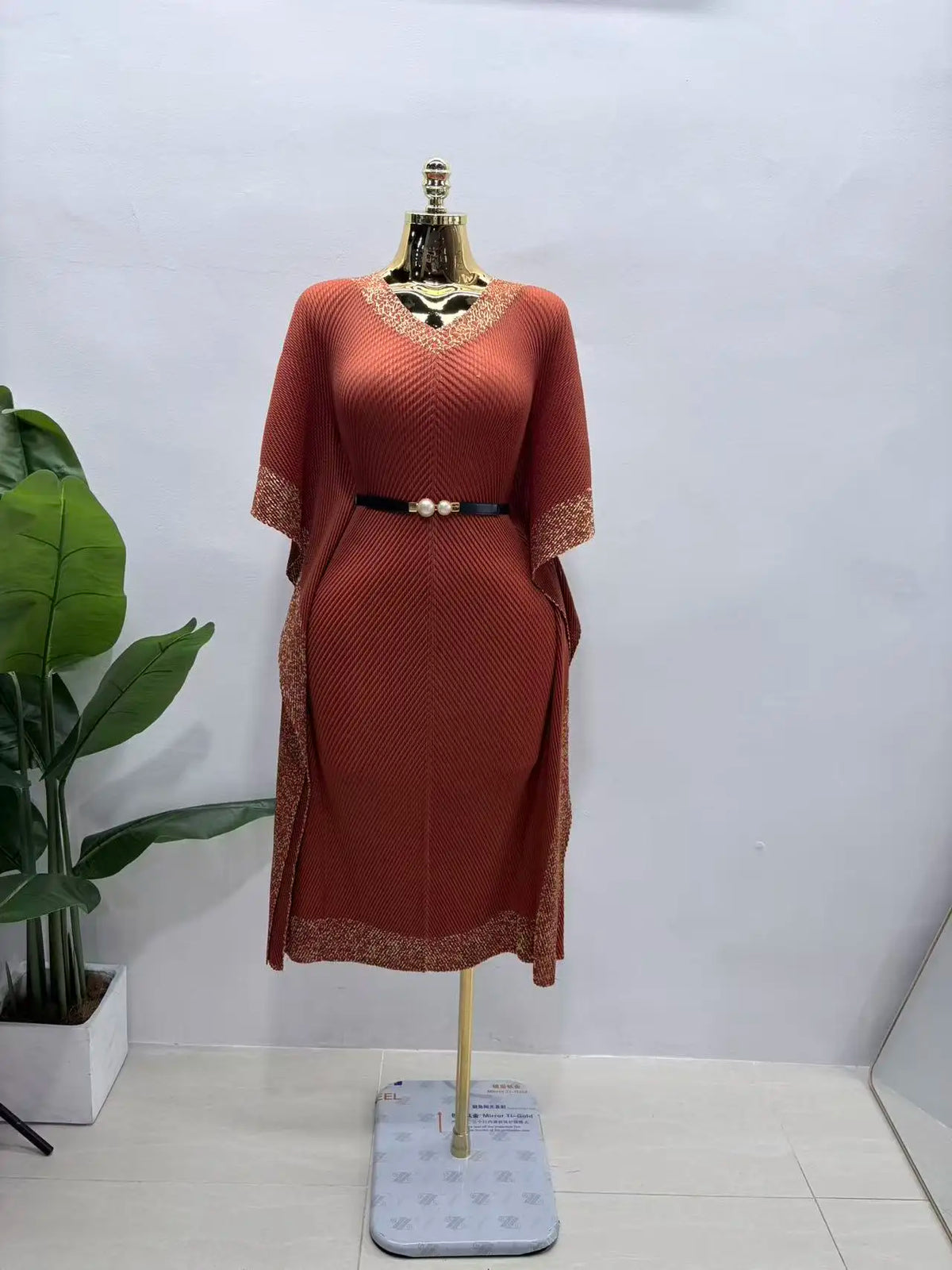 Africa New V-neck bat sleeve long dress with dragon scale pleats, fringe details, and bronzing accents from JN Fashion Fusion.